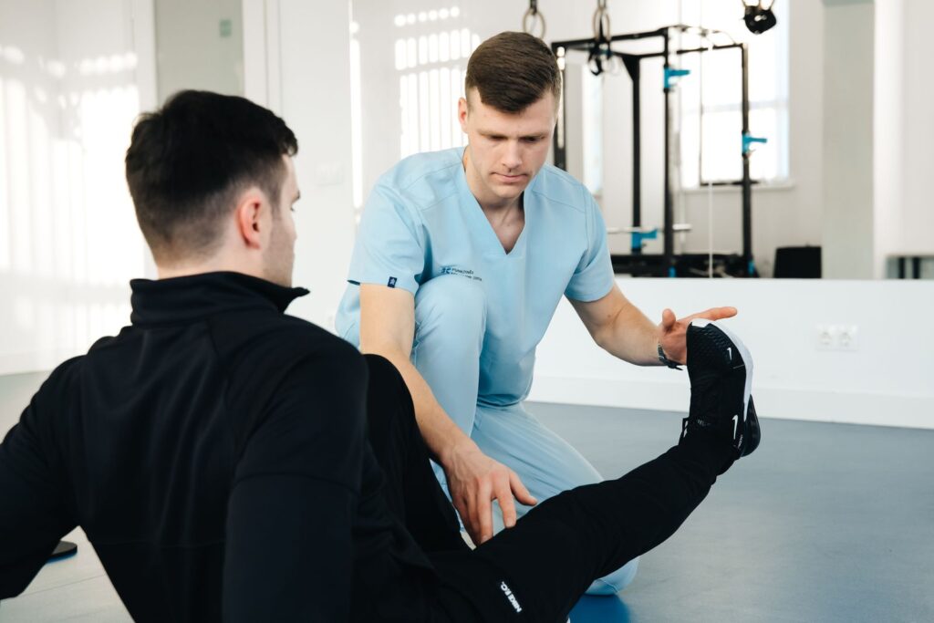 Physiotherapist helping a patient with leg exercises